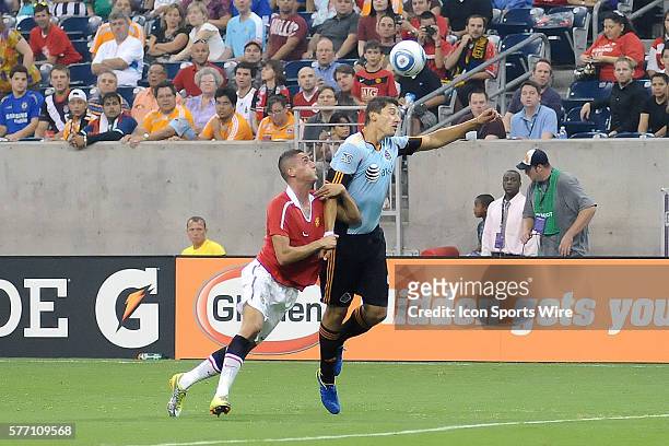 Omar Gonzalez of the MLS All-Stars is held by Federico Machedo of Manchester United during the MLS All-Star game. Manchester United defeated the MLS...