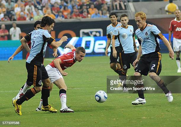 Tom Cleverley of Manchester United muscles his way through a crowd of MLS All-Stars during the MLS All-Star game at Reliant Stadium in Houston, TX....