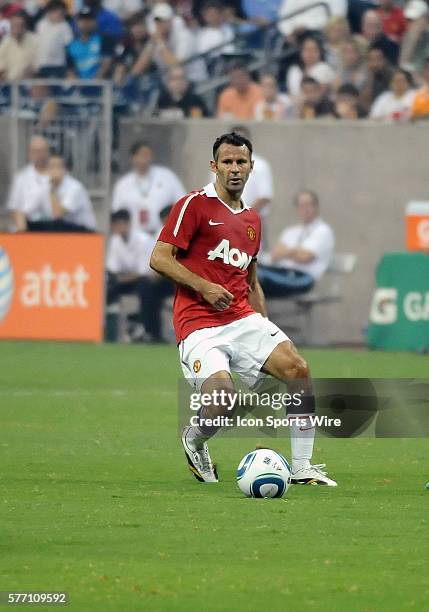 Ryan Giggs of Manchester United looks for an open pass as he works the ball down field during the MLS All-Star game. Manchester United defeated the...