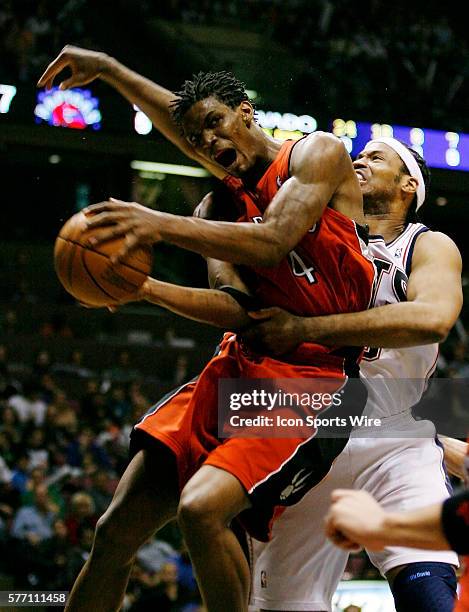 Nets Jason Collins fouls Raptors Chris Bosh in the second half during the New Jersey Nets 102-89 victory over the Toronto Raptors in game three of...