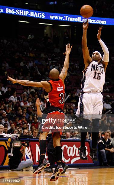 Nets Vince Carter shoots over Raptors Juan Dixon in the first half during the New Jersey Nets 102-89 victory over the Toronto Raptors in game three...