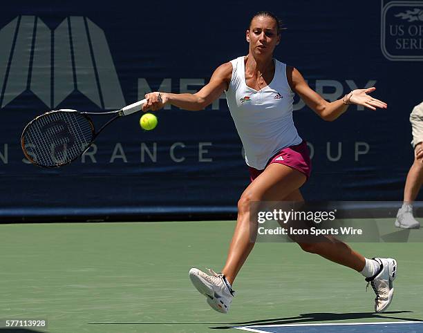 Flavia Pennetta reaches to hit a return shot during a semifinal match against Svetlana Kuznetsova at the Mercury Insurance Open played at the La...