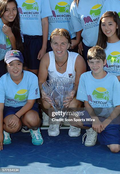 Svetlana Kuznetsova posses with the ball kids with the winners trophy after defeating Agnieszka Radwanska in the finals of the Mercury Insurance Open...