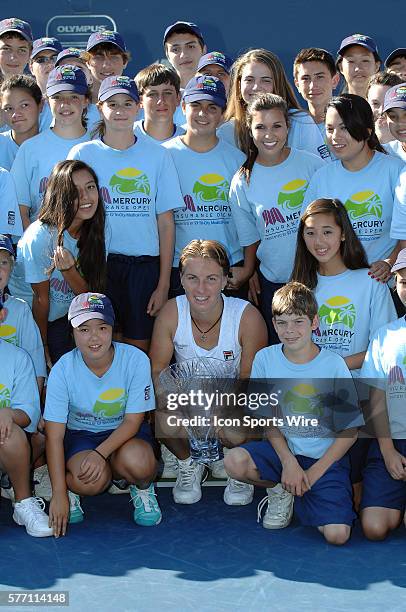 Svetlana Kuznetsova posses with the ball kids with the winners trophy after defeating Agnieszka Radwanska in the finals of the Mercury Insurance Open...