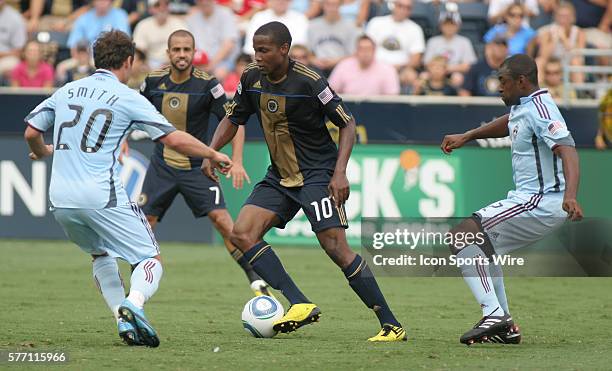 Philadelphia Union's Danny Mwanga tries the keep the ball away from Colorado defenders Jamie Smith and Marvell Wynne during the first half of the...