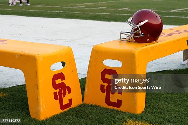 Trojan helmet sits on a yellow bench with the SC logo on it during a USC scrimmage held in the Los Angeles Memorial Coliseum in Los Angeles, CA.