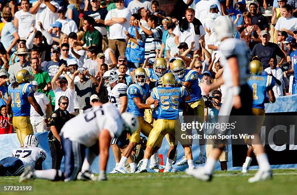 The UCLA Bruins 11 Dennis Keyes 55 Korey Bosworth and 42 Chad Moline celebrate a touch down while BYU is dejected in the foreground 55 Jeff Rhea...