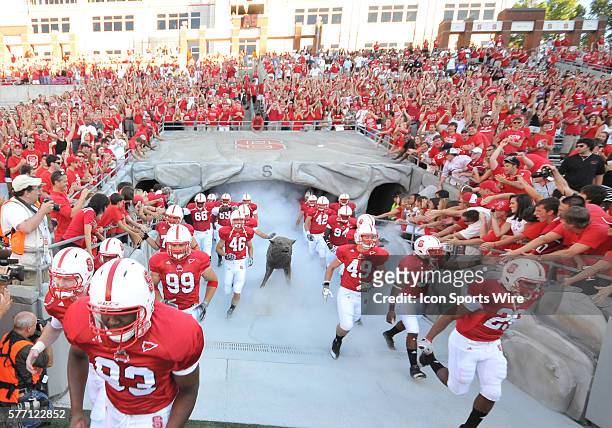 The Wolfpack run onto the field at Carter-Finley Stadium in Raleigh,NC