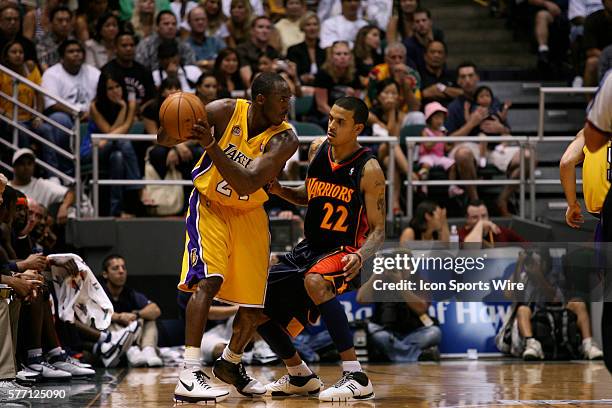 Matt Barnes of the Golden State Warriors defends Kobe Bryant of the Los Angeles Lakers during an NBA game at the Stan Sheriff Center in Honolulu, HI.