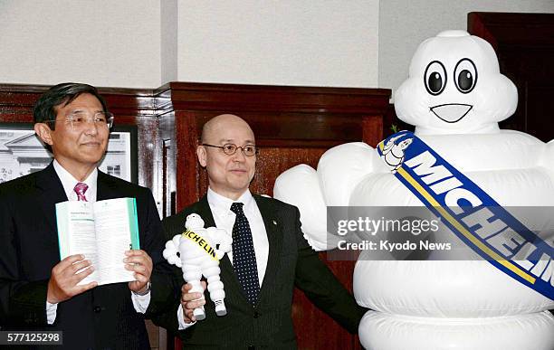 Japan - Tetsushi Morita , a senior official of Nihon Michelin Tire Co., the Japanese arm of the French tire company Michelin, and Michelin Man, the...