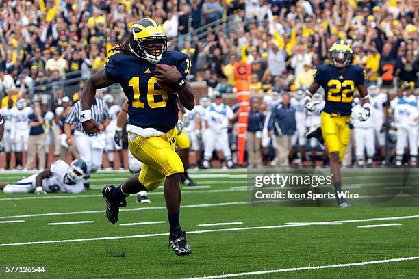 September 2010; Connecticut at Michigan; Michigan Wolverines quarterback Denard Robinson scores a touchdown during the first quarter; Ann Arbor,...