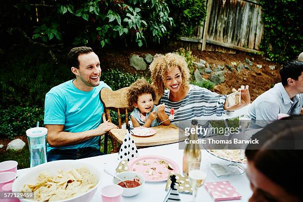 smiling parents and daughter taking self portrait - plate eating table imagens e fotografias de stock