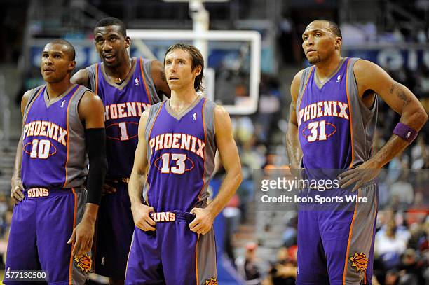 Standing Phoenix Suns guard Leandro Barbosa , center Amare Stoudemire , guard Steve Nash , and forward Shawn Marion wait for a fouls shot to be...