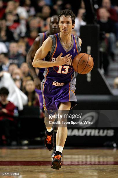 Phoenix Suns guard Steve Nash dribbles the ball upcourt trailed by center Shaquille O'Neal during their NBA basketball game against the Portland...
