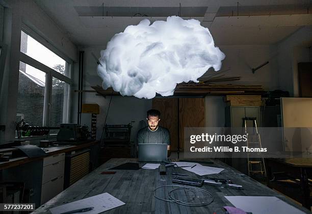man sitting at workbench working on prototype - prototype stock pictures, royalty-free photos & images