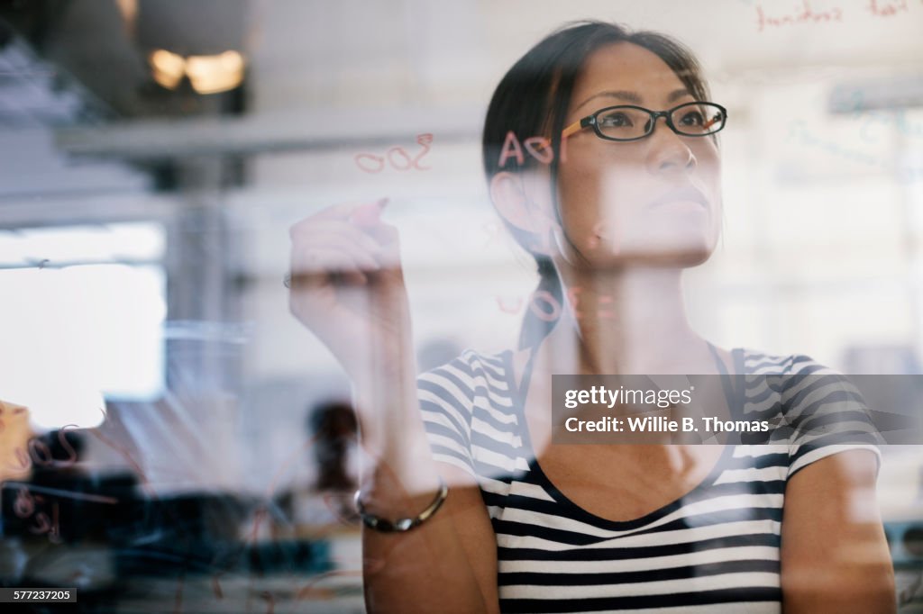 Woman looking over electronic schematic