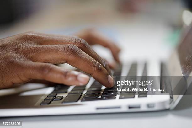 closeup of black woman typing on laptop - hand typing stock pictures, royalty-free photos & images