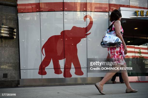 Woman walks past the elephant logo of the Republican Party on the first day of the Republican National Convention on July 18, 2016 in Cleveland,...