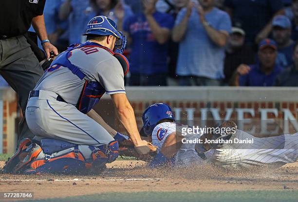 Travis d'Arnaud of the New York Mets tags out Willson Contreras of the Chicago Cubs in the 3rd inning at Wrigley Field on July 16, 2016 in Chicago,...