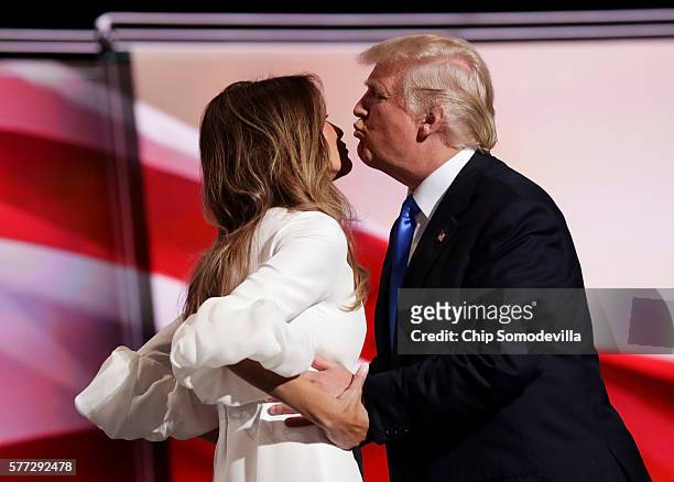 Presumptive Republican presidential nominee Donald Trump kisses his wife Melania before she delivers a speech on the first day of the Republican...