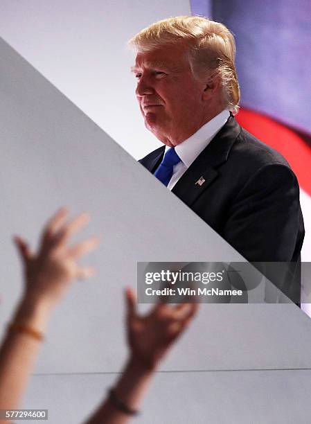 Presumptive Republican presidential nominee Donald Trump walks off stage as a sign language interpreter translates his wife Melania's speech on the...