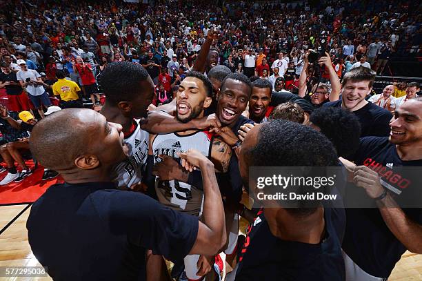 Denzel Valentine of the Chicago Bulls celebrates with his teammates after hitting the game winning shot against the Minnesota Timberwolves during the...