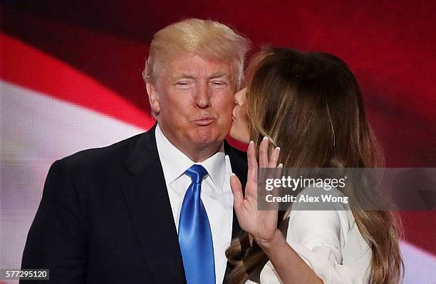 Melania Trump kisses her husband and presumptive Republican presidential nominee Donald Trump, after delivering a speech on the first day of the...