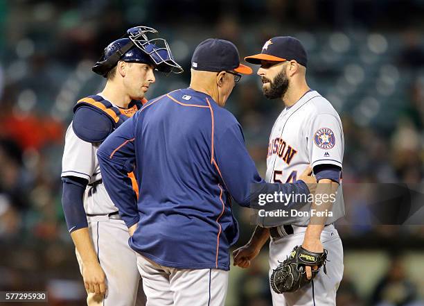 Mike Fiers of the Houston Astros receieves advice in the bottom of the fourth against the Oakland Athletics at the Oakland Coliseum on July 18, 2016...