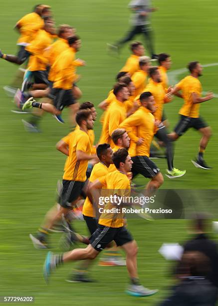 Players run laps during warm up after the Juventus FC welcome ceremony at Lakeside Stadium on July 19, 2016 in Melbourne, Australia.