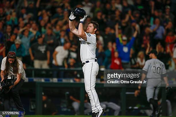 Adam Lind of the Seattle Mariners "jump shoots" his helmet as he crosses home plate following a 3-run walk off home run to beat the Chicago White Sox...