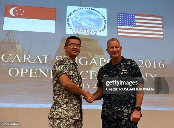 Navy Rear Admiral Brian Hurley , commander of Logistics Group Western Pacific/Task Force 73 shakes hands with Republic of Singapore Navy Fleet...