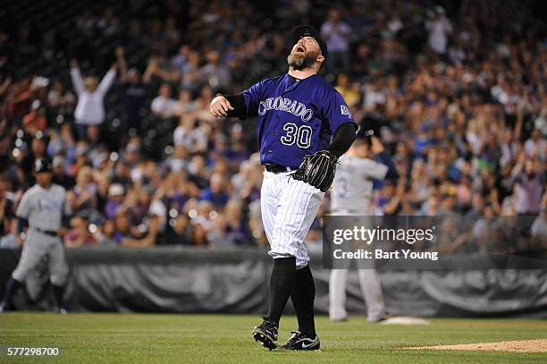 Jason Motte of the Colorado Rockies reacts to the third out in the eighth inning against the Tampa Bay Rays at Coors Field on July 18, 2016 in...