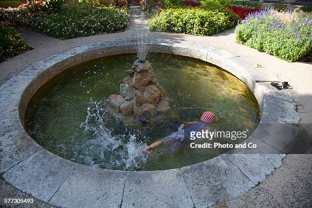 child playing in the fountain - kids swim caps stock pictures, royalty-free photos & images
