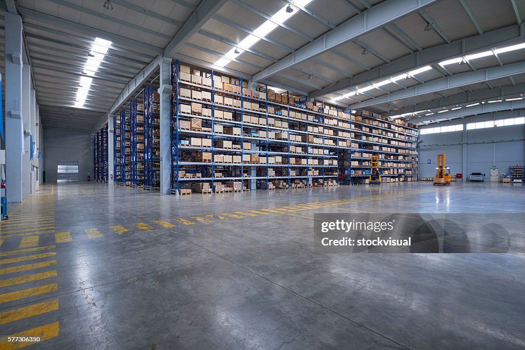 Cardboard boxes on shelves in warehouse