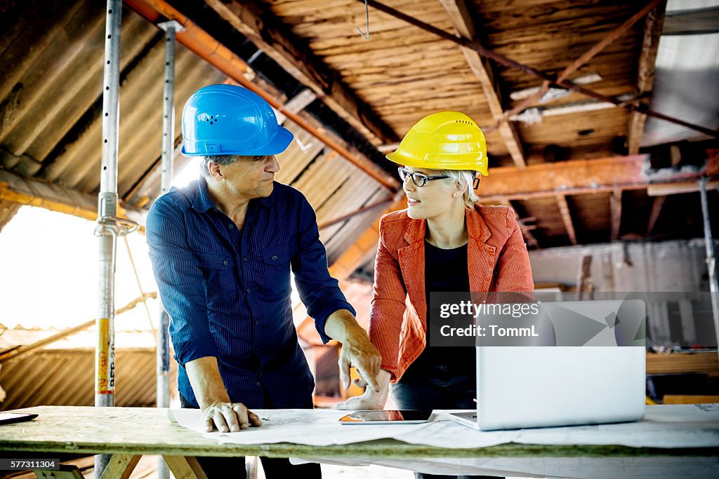 Architect And Construction Worker With Plans, Tablet PC And Laptop