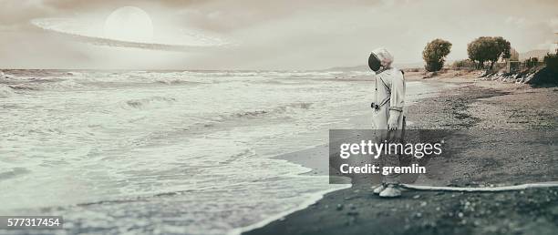 lonely astronaut on the beach - moon shore stock pictures, royalty-free photos & images