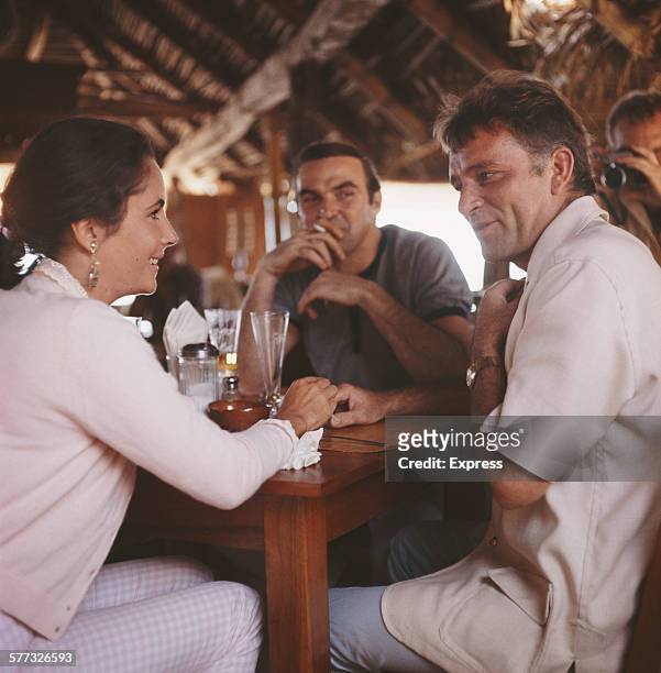 Actors Elizabeth Taylor , Stanley Baker and Richard Burton in a bar, Puerto Vallarta, Mexico, 12th January 1964. Burton is in Mexico for location...