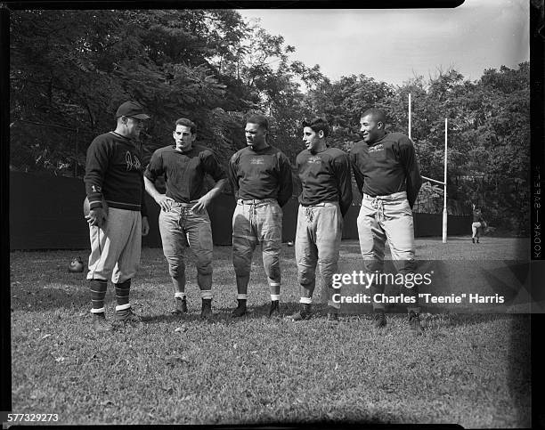 University of Pittsburgh football coach Mike Milligan, and football players Carl DePasqua, Bobby Lee, Bimbo Cecconi, and Jimmy Joe Robinson, standing...