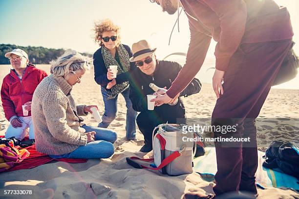 happy hour for group of friends on beach in spring. - apero stock pictures, royalty-free photos & images
