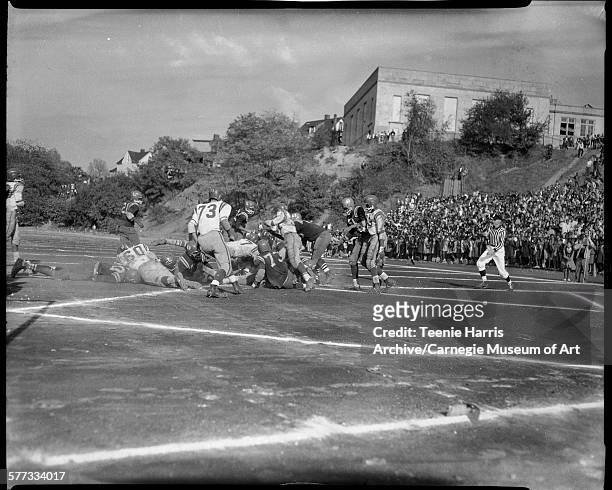 Schenley and Westinghouse High School football game, including player no 73 Dennis Cunahan, at Westinghouse field, Pittsburgh, Pennsylvania, October...