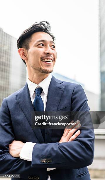 business japanese standing with arm crossed - anticipation face stock pictures, royalty-free photos & images