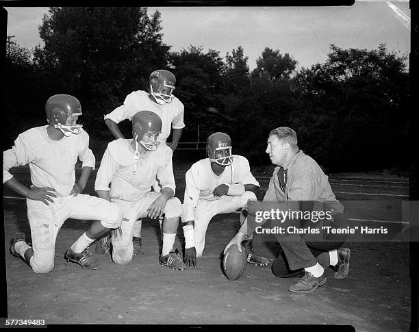 Westinghouse High School football coach Pete Dimperio talking to football players from left: Jon Henderson, John Brewer Jr, Melvin Myricks, and...