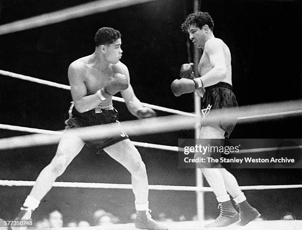 Joe Louis looks to deliver a right jab on his opponent Max Baer during their bout at Yankee Stadium in Bronx, New York, September 24, 1935. Joe Louis...