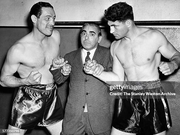 Max Baer and Lou Nova face off after the weighing in at the State Athletic Commission Offices as Eddie Cantor finds himself in the middle of the two...