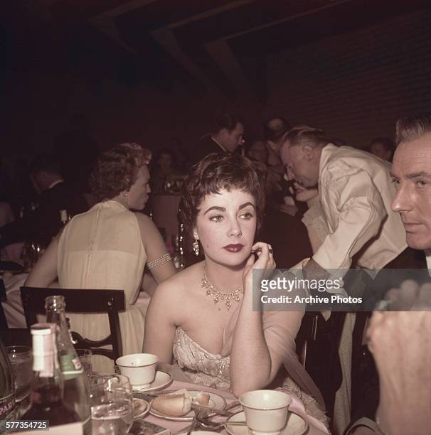 British-born American actress Elizabeth Taylor with her husband, British actor Michael Wilding at the 26th Academy Awards, held at the RKO Pantages...