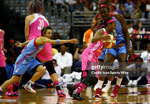 Ivory Latta of the Washington Mystics crashes into Aneika Henry of the Atlanta Dream during a WNBA game at Verizon Center, in Washington D.C. Mystics...