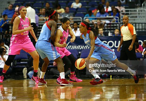 Kara Lawson of the Washington Mystics tries to move into the path of Aneika Henry of the Atlanta Dream during a WNBA game at Verizon Center, in...