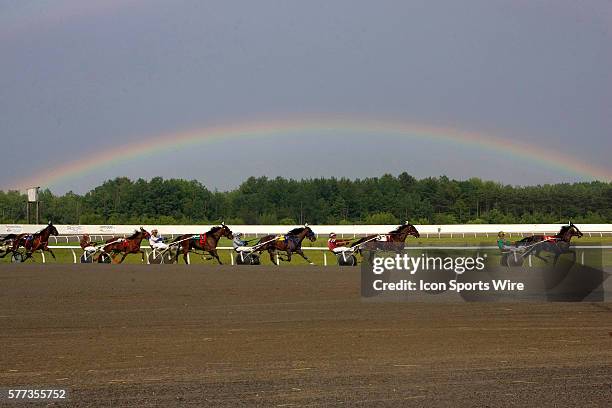 Leigh Fitch driving RUN HOLLY RUN leads the race going into the stretch and under the rainbow Friday at Scarbrough Downs in Scarborough Maine despite...