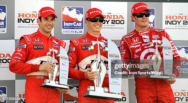 Driver Helio Castroneves, Ryan Briscoe and Scott Dixon celebrate after the Honda Indy 200 at Mid Ohio.