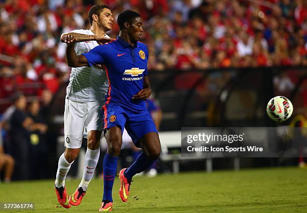 Tyler Blackett of Manchester United goes for a loose ball with Mauro Icardi of Inter Milan during an International Champions Cup match at Fedex...